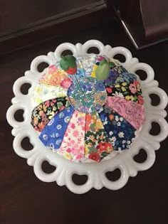 a white plate topped with lots of colorful fabric