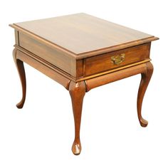 a wooden table with drawers on it and an open drawer at the top that has gold handles