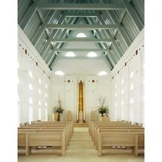 an empty church with wooden pews and windows