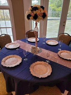 the table is set with plates and place settings