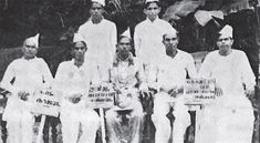 an old black and white photo of men holding signs