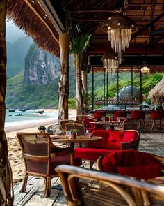 an outdoor dining area with red chairs and tables