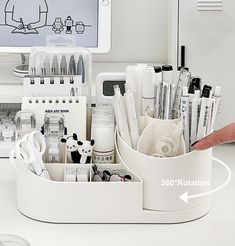 a white container filled with lots of different types of pens and pencils on top of a table