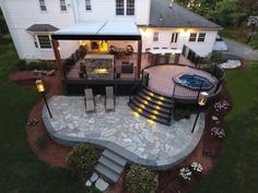 an aerial view of a house with a patio and fire pit in the middle of it