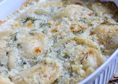 a casserole dish with cheese and herbs in it