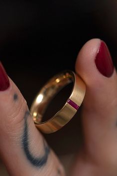 a close up of a person's finger with a ring on it