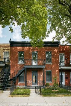 an apartment building with stairs leading up to the second story