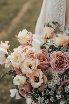 a woman holding a bouquet of flowers in her hands