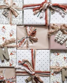 many wrapped presents are laid out on top of each other