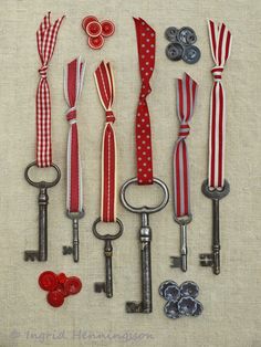 an assortment of keys with red, white and blue ribbon on them are arranged next to each other