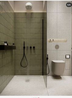 a bathroom with a toilet, sink and shower in it's stall area next to a wall mounted faucet