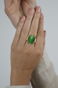 "Cats Eye Gump Signed Ring in 14K Yellow Gold . Invest in luxury with this vintage Gump signed dome solitaire ring, featuring a vivid green Cats Eye , shaped into an oval cabochon, and secured with a 4-prong setting. Crafted from 14K yellow gold, this ring features a geometric shape to its shank and base.  Item Details: - Type: Vintage Dome Ring  - Metal: 14K Yellow Gold  - Weight: 18.04 Grams  - Setting: Prong  Center Stone Details: - Type: Cats Eye   - Cut: Cabochon, Oval  - Color: Green  ★ Ce Elegant Green Oval Enamel Ring, Green Oval Enamel Ring For Formal Occasions, Formal Oval Green Enamel Ring, Formal Green Oval Enamel Ring, Elegant Green Domed Rings, Luxury Green Domed Ring, Green Cabochon Dome Ring For Formal Occasions, Vintage Cats, Natural Cat