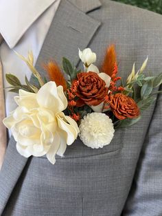 a man in a gray suit with flowers on his lapel flower bouquet is shown