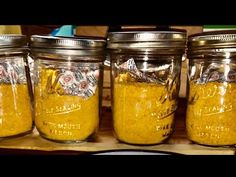 four mason jars filled with yellow colored food