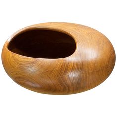 a wooden vase sitting on top of a white surface