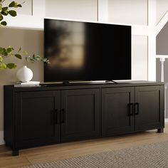 a flat screen tv sitting on top of a wooden cabinet