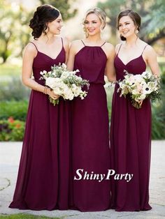 three bridesmaids in purple dresses standing together