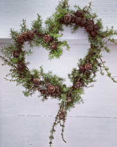 a wreath made out of branches and pine cones