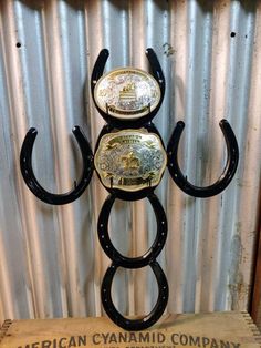 This display is perfect for showing off your trophy buckles from rodeos and horse shows, or to show off a collection of Western buckles. This buckle holder hangs on a wall, and holds up to 6 buckles.Handmade by a professional welder using genuine, unused steel horse shoes. Belt Buckle Display, Buckle Display, Horses Stuff, Country Room, Horseshoe Crafts Projects, Cool Welding Projects, Ribbon Display, Metal Welding Art, Rodeo Time