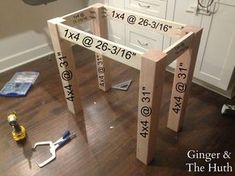 a table that is made out of wood with numbers on it and tools next to it