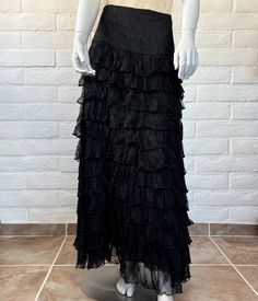 This is an AMAZING early design (very late 90s or early 00s) from Marrika Nakk, known for her romantic Western wear fashions. The skirt is constructed from cascading black lace ruffles topped with wide fitted waist panel. It's fully lined (just the bottom couple of inches are sheer) and finished with a side zipper. This is a fabulous, versatile piece that could be styled as Western or goth or boho - it would look great so many ways! The label reads Marrika Nakk. Measurements: no tag; this is approx a size medium. The waist measures 30" (meant to fit a bit low) and the seam at the bottom of the waist panel measures 36" (would hit at high or mid hip on most). It's 43" long. Material: no tag; feels like nylon. Condition: freshly hand laundered and in excellent vintage condition. There's a ver Black Vintage Ruffled Skirt, Y2k Style Fitted Ruffled Skirt, Y2k Fitted Tiered Skirt Bottoms, Y2k Style Long Fitted Skirt, Vintage Fitted Maxi Skirt For Party, Fitted Vintage Maxi Skirt For Party, Y2k Fitted Ruffled Skirt, Y2k Style Fitted Skirt With Ruffles, Y2k Fitted Skirt With Ruffles