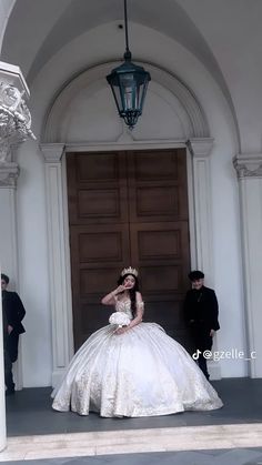 a woman in a wedding dress is standing on the steps with her hands behind her head