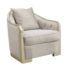 a beige chair with a pillow on it's back and gold trim around the arm