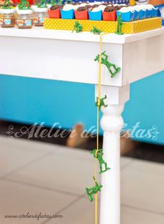 the table is set up with cupcakes and candy bars on it's legs