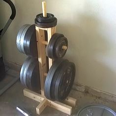 there is a gym equipment set up in the corner with two dumbbells on it