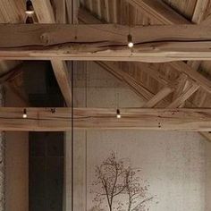 the interior of a room with wood beams and paintings on the wall