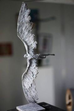 a sculpture of a bird on top of a table