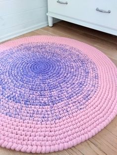 a pink and purple rug on the floor