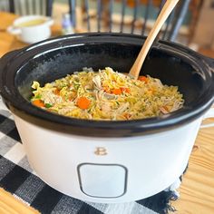 a slow cooker filled with food on top of a table