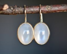 Lovely genuine white moonstone cabs are set in 14k gold. Lightweight and gorgeous, these are a great gift for anyone on your list. Perfect for everyday wear or for those who like to make a dainty minimalist statement. The moonstone drops are have a lovely luster and are luminescent. Size : 10mm Metal : 18kt Gold Gemstones : 12 ct White Sri Lankan Moonstone More about Moonstone ... Rainbow Moonstone acts as a prism, diffusing energy throughout the aura. It is said to provide psychic protection, c Moonstone Birthstone, April Birthstone Jewelry, Bezel Earrings, Psychic Protection, Yellow Gemstones, White Moonstone, Earring Gift, Solid Gold Earrings, Rose Quartz Ring