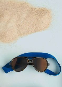 This pair of sunglasses feature tortoise and blue details. It comes with a removable neoprene neck strap and is intended for ages 0-2 years. Pastic UV400 Protection Polarized Aviator Sunglasses For Summer Outdoor Activities, Sporty Summer Beach Sunglasses, Summer Outdoor Aviator Sunglasses With Adjustable Fit, Sporty Sunglasses With Mirrored Lenses For Beach, Sporty Mirrored Sunglasses For Beach, Sporty Sunglasses With Uva Protection For Beach, Beach Aviator Sunglasses With Uv Protection, Brown Aviator Sunglasses With Uv Protection For Beach, Adjustable Sunglasses For Summer Travel