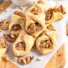 several pastries on a cutting board with walnuts