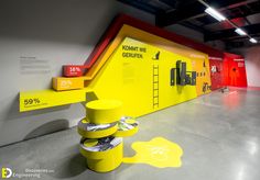 a yellow and red display in a building with stairs leading up to the second floor