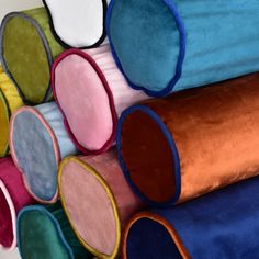 several different colored rugs stacked on top of each other in the shape of circles