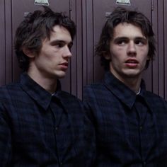 two young men standing next to each other in front of lockers with their mouths open