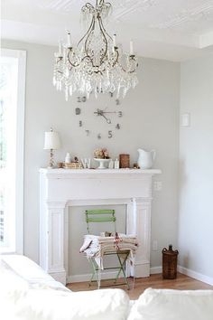 a room with a fireplace and chandelier in it