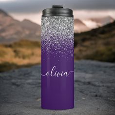 a purple and white glittered water bottle with the name aurora on it