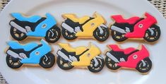 decorated cookies in the shape of motorbikes on a plate