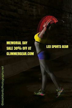 a woman is running in the dark with neon shoes