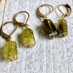 Let your inner Earth Goddess shine through with these lovely green peridot crystals. Simple enough for everyday but also powerful healers and elegant in an earthy, woodsy way. They hang from simple leverback ear wires in your choice of brass or gold fill. Each pair of these 100% natural stones are unique and ready to gift to that someone special. *The color ranges in these natural stones but all fall pretty close to the colors in the photos. Choose which color suits you best from the drop down m Nature-inspired Green Jewelry With Matching Earrings, Green Nature-inspired Everyday Jewelry, Everyday Green Nature-inspired Jewelry, Green Spiritual Earrings With Natural Stones, Spiritual Green Earrings With Natural Stones, Green Earrings With Natural Stones As Gift, Green Spiritual Earrings For Healing, Green Hypoallergenic Nature-inspired Jewelry, Nature-inspired Hypoallergenic Green Jewelry