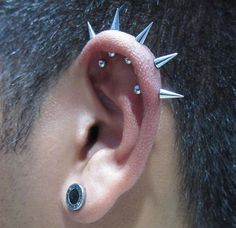 a man with spiked ears and piercings on his ear