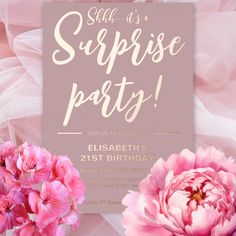 pink flowers are in front of a surprise party card