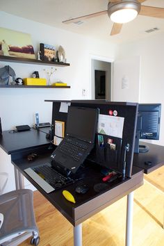 a laptop computer sitting on top of a desk next to a keyboard and mouse pad