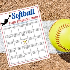 a softball sitting on top of a baseball field next to a scoreboard and ball