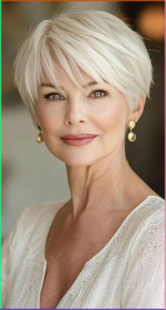 Attention silver beauties! Explore 34 chic short haircuts designed specifically for women over 60. These flattering styles will enhance your natural beauty and take years off your appearance. From textured crops to sophisticated bobs, find the perfect low-maintenance cut that suits your lifestyle and personality. Embrace your age with confidence and style! Short Bob Hairstyles Women Over 50, Low Maintenance Pixie Bob Haircut, Back View Short Haircuts, Short Hair For 80 Year Old Women, Short Hairstyle Women 60 Years Old, Short Bob Cuts For Women, Short Hair For 60 Year Old Women, Haircut For Short Hair For Women, Wedge Haircut For Women Over 50