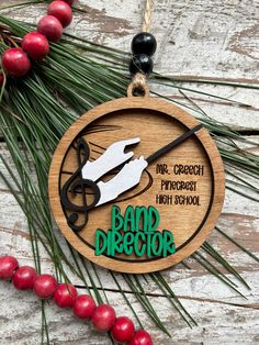 a wooden ornament with scissors and the words beard director hanging from it's side